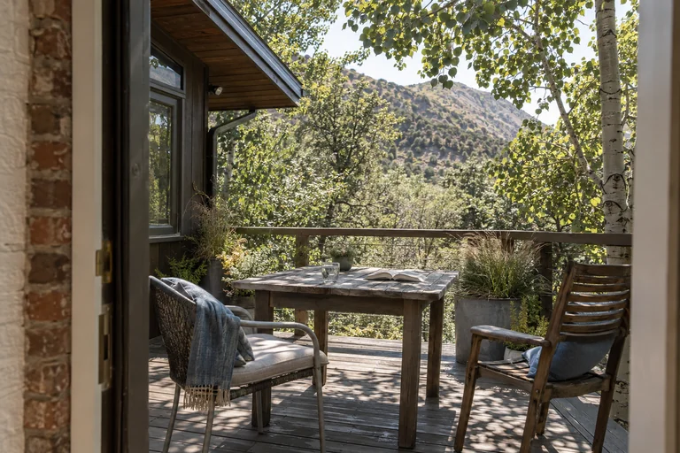 AI-generated summer terrace with outdoor chairs in aspen shade